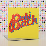 Welsh New Baby Card, Babi Bach, Red on yellow background, with gold foil